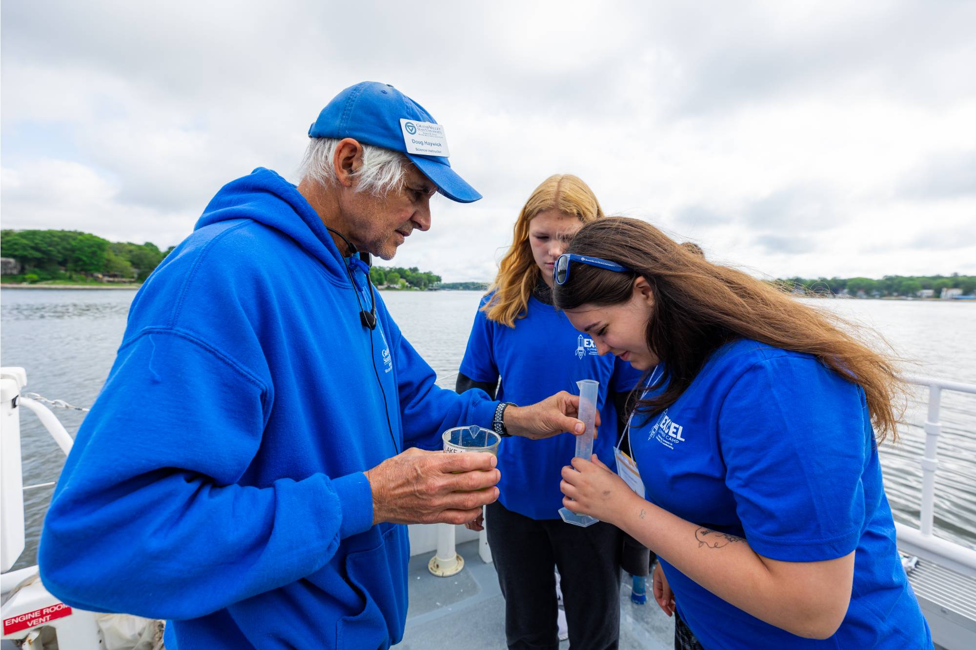 AWRI vessel instructor Doug Haywick assists students with a plankton density test onboard the D.J. Angus
